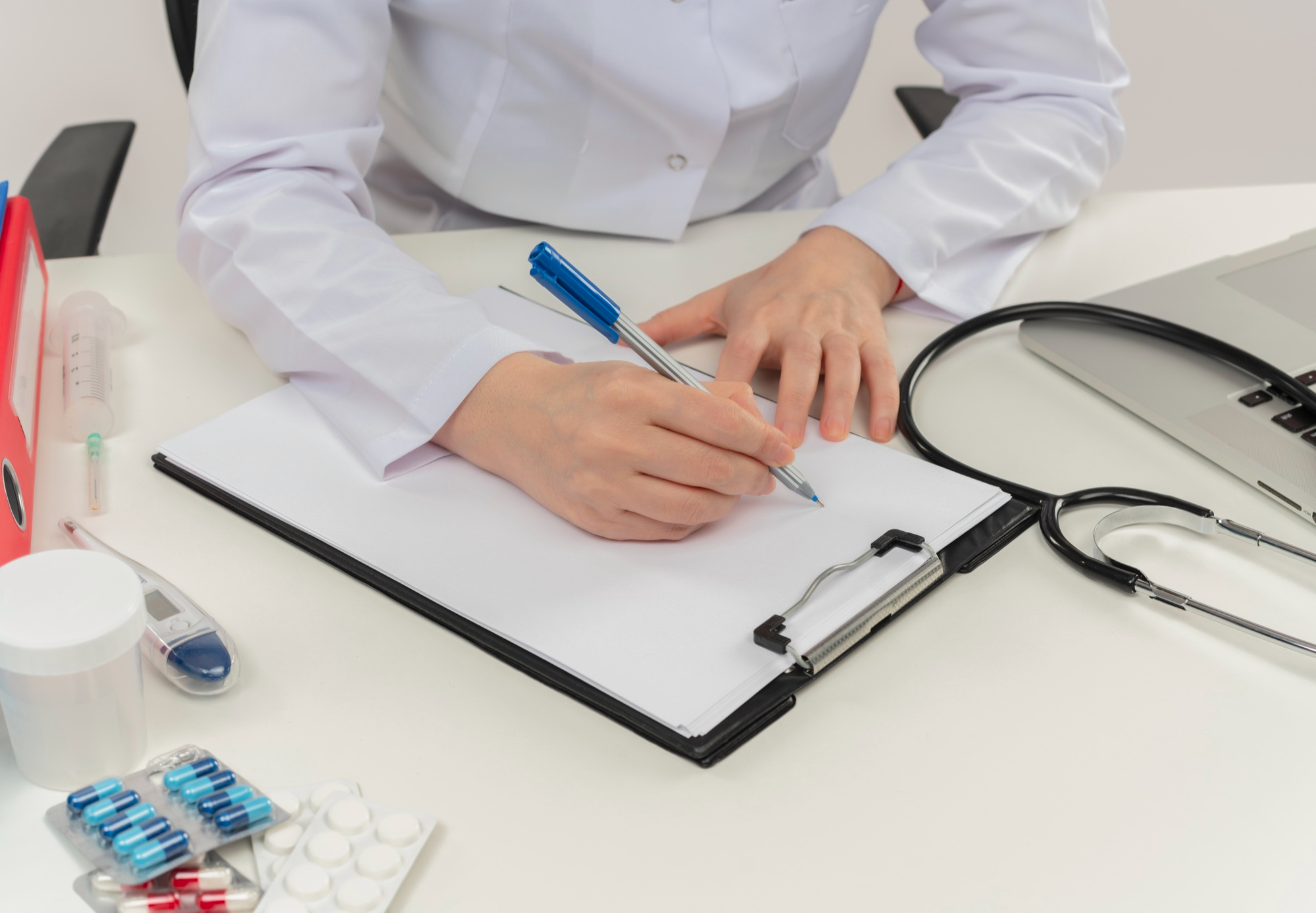 Doctor writing clinical notes